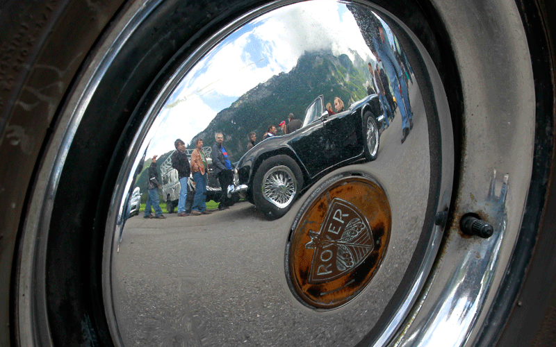 A vintage Triumph TR4 sports car is reflected in the wheel cap of a Rover limousine during the British Car Meeting 2010 in the village of Mollis some 80 kilometres east of Zurich. (REUTERS)