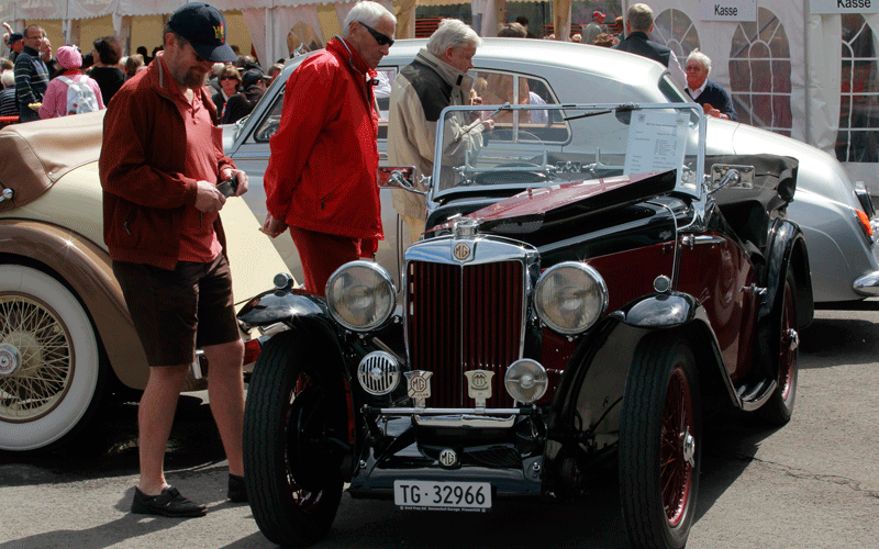 People stand beside a vintage MG sports car during the British Car Meeting 2010 in the village of Mollis some 80 kilometres east of Zurich. (REUTERS)