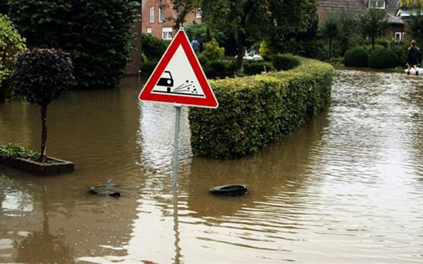 A traffic sign is seen in a flooded street in Wettringen near the western town of Muenster. Parts of Steinfurt and Osnabrueck were flooded after heavy rainfalls last night. (REUTERS)