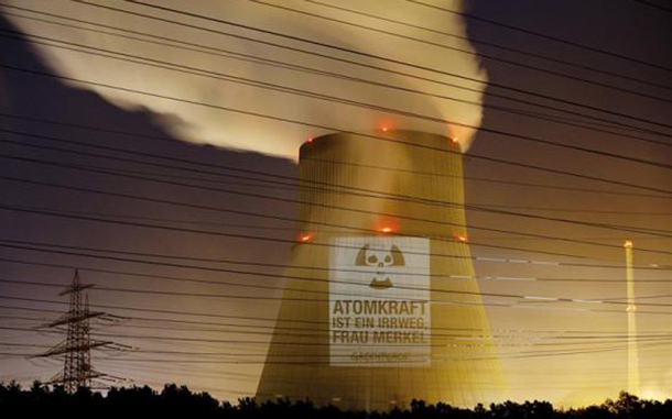 Greenpeace activists protest with a projection on the cooling tower of Emsland nuclear power plant in Lingen to call on German Chancellor Angela Merkel not to cling to the extension of the operation time of nuclear power plants in Germany. The text reads: 'Nuclear power is a wrong way, Mrs Merkel.' (REUTERS)