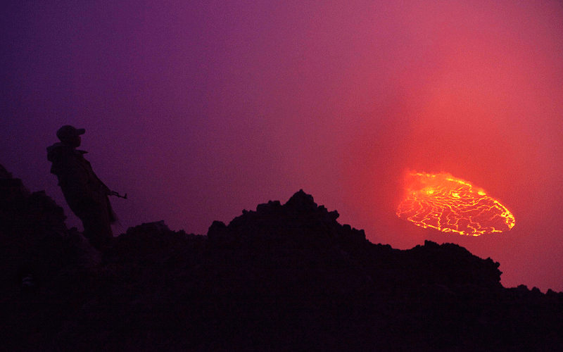 A Congolese soldier and guard for Virunga National Park looks down into a lava lake boiling in the crater of Nyiragongo volcano near Goma in eastern Congo. The 3,175m Nyiragongo erupted in 2002, killing nearly 50 people and forcing some 400,000 Goma residents to flee their homes as lava oozed through the city centre, destroying about 15 per cent of the town. (REUTERS)