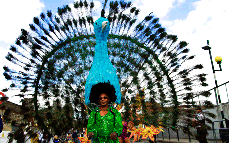 A costumed reveller performs in the Notting Hill Carnival in London. (AP)