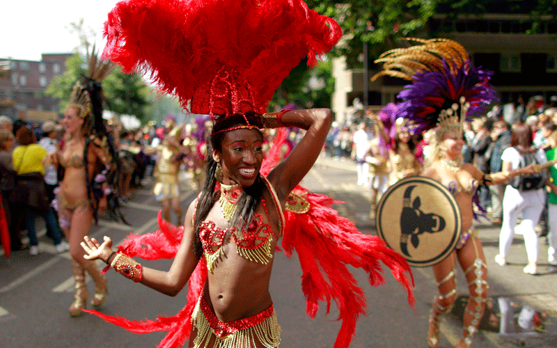 A costumed reveller performs in the Notting Hill Carnival in London. (AP)