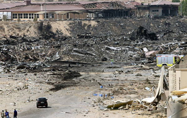 United Arab Emirates (UAE) officials (L) are seen at the site where a cargo airplane crashed while taking off from Dubai airport, United Arab Emirate. (EPA)