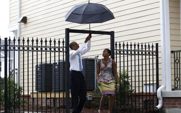 President Barack Obama and first lady Michelle Obama walk through a gate in the Columbia Parc Development to visit newly built homes in New Orleans, Louisiana. (REUTERS)