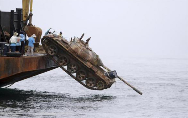 Officials dump a Chinese-made T-69 armoured tank into the Gulf of Thailand, near the southern Narathiwat province. The 25 decommissioned Thai-army tanks will form artificial corals to improve the marine ecosystems and increase fish stock in the area. (REUTERS)