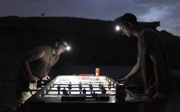 Canadian soldiers play table football under flashlights at a military outpost near the village of Bazaar e Panjwaii, in the Panjwaii district of Kandahar province, Afghanistan. (REUTERS)