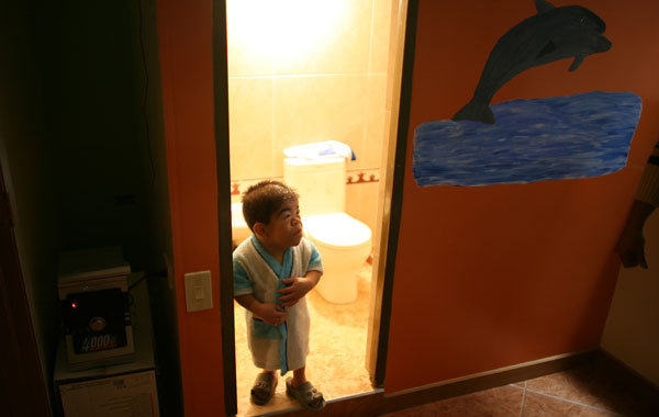 Edward Nino Hernandez, 24, stands in the doorway of his bathroom in Bogota, Colombia. (AP)