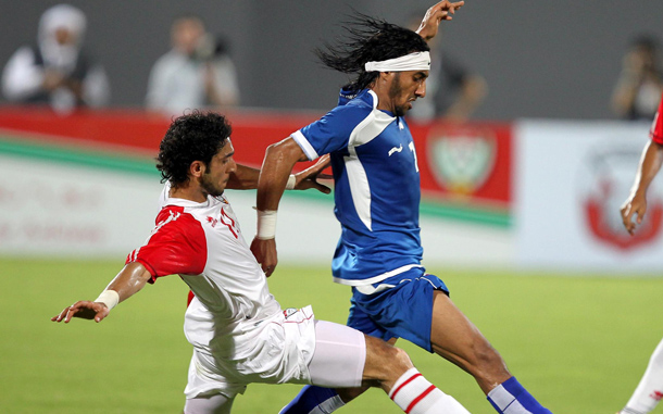 UAE player Yousif Jabber (L) fights for the ball with Fahad AlEnezi (R) player of Kuwait during their friendly soccer match at Al-Nahyan stadium in Abu Dhabi, United Arab Emirates. (EPA)