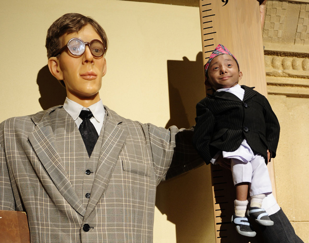 Khagendra Thapa Magar, the world's smallest teen, is held next to a life-sized figure of Robert Wadlow, the world's tallest man ever, to mark his introduction into "Ripley's Believe It or Not" latest book during a photo shoot on Times Square in New York. The Nepalese 17-year old made his entry into the record book as the world's smallest male teen standing just 55.9 centimetres (22 inches) tall. (AFP)