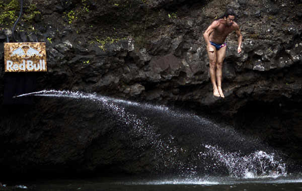 Orlando Duque of Colombia preparing for a water entry after diving from the 27-metre platform at Kawainui Falls during the sixth and final round of the 2010 Red Bull Cliff Diving World Series in Hilo, Hawaii. (AFP)