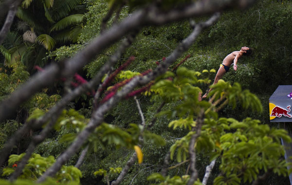 Cyrille Oumedjkane of France diving from the 27-metre platform at Kawainui Falls during the sixth and final round of the 2010 Red Bull Cliff Diving World Series in Hilo, Hawaii. The series was won by Gary Hunt of England. (AFP)