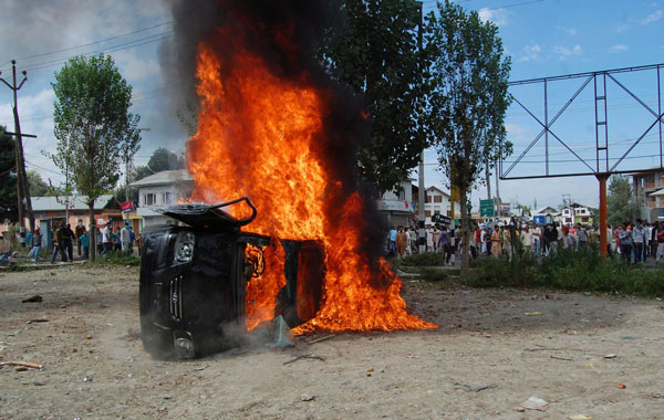 A private vehicle belonging to a police officer burn after it was set on fire by Kashmiri Muslim protesters during a protest in Srinagar, the summer capital of Indian Kashmi. (EPA)