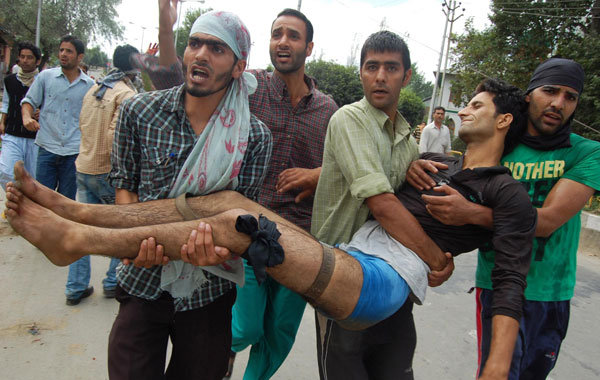 Kashmiri Muslims carry wounded protester during a protest in Srinagar, the summer capital of Indian Kashmir. (EPA)