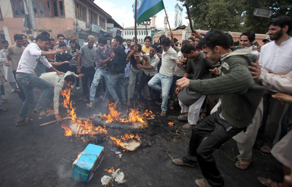 Kashmiri protesters stamp on the remains of an effigy of U.S. President Barack Obama after burning it during a protest in Srinagar. (EPA)