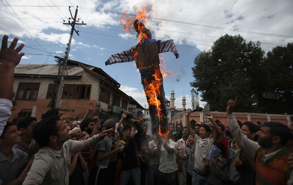 Kashmiri protesters lift and burn an effigy of US President Barack Obama during a protest in Srinagar, India. (AP)