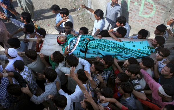 Kashmiri men carry the body of Nisar Ahmad Kuchay, who died during a protest, at his funeral on the outskirts of Srinagar. (AFP)