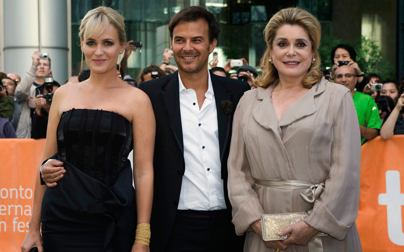 French actress Judith Godreche (L), French director Francois Ozon (C) and French actress Catherine Deneuve (R) arrive at the gala presentation for the film "Potiche" during the 35th Toronto International Film Festival. (REUTERS)