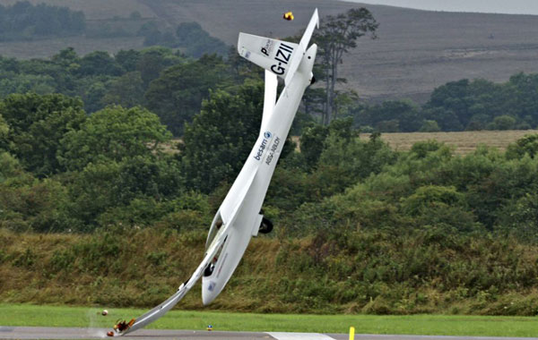 Impact: One wing-tip hits the ground, and the entire wing bends. (FILE)