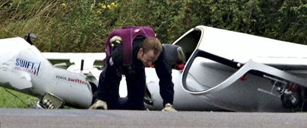 Close call: Mr Newman crawls from his smashed up stunt glider. The pilot suffered three cracked vertibrae but he will make a full recovery. (FILE)