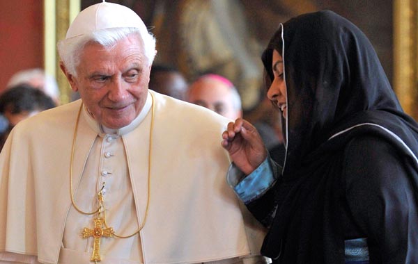 Pope Benedict XVI, arrives with the Co-Chairman of Britain's Conservative Party, Baroness Sayeeda Warsi, for a meeting of religious leaders at St Mary's University College, in Twickenham, south-west London. (AFP)