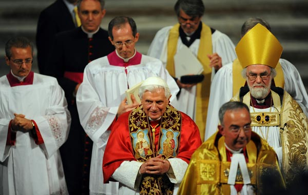 The Archbishop of Canterbury, Rowan Williams, (R) walks with Pope Benedict XVI (C) following a Celebration of Evening Prayer, at Westminster Abbey. (GETTY IMAGES)