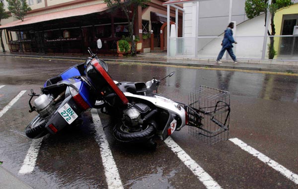 Mopeds blown over by strong winds are seen on the street in Hamilton as Hurricane Igor moves onto Bermuda. (AP)