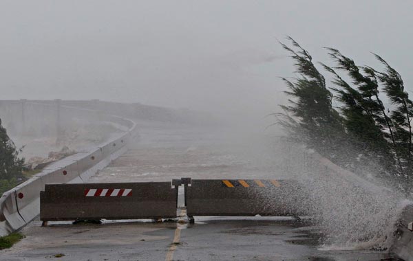 High winds pushes water over the closed causeway leading to Wade International Airport as Hurricane Igor moves ashore in Bermuda. (AP)