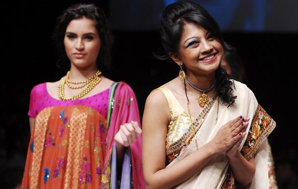 Anupama Dayal (R) acknowledges the audience's applause after the launch of her latest collection at the Lakme Fashion Week Winter/Festive 2010 Grand Finale in Mumbai, India. (EPA)