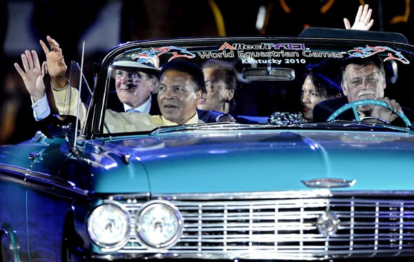 US boxing legend Muhammad Ali (L) waves to the crowd as he rides around the arena in a car during the Opening Ceremony for the World Equestrian Games in Lexington, Kentucky, USA. (EPA)