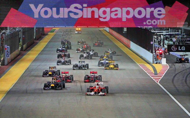 Spanish Formula One driver Fernando Alonso (front) of Scuderia Ferrari leads the pack at the start of the Singapore Formula One Grand Prix night race at the Marina Bay Street Circuit in Singapore. (EPA)