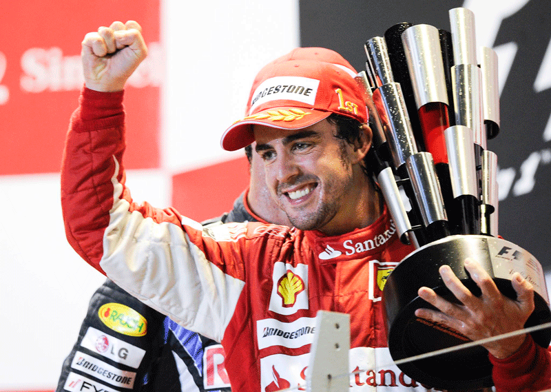 Spaniard Fernando Alonso of Ferrari holds the trophy after winning the Singapore Formula One Grand Prix. (EPA)