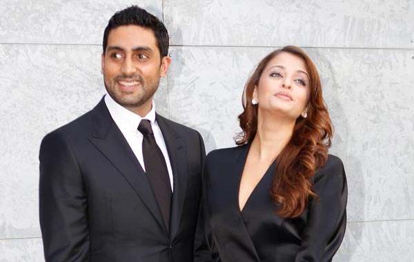 Aishwarya Rai and her husband Abhishek Bachchan pose prior to attending the presentation of the Armani Spring-Summer 2011 fashion collection, during the fashion week in Milan, Italy. (AP)