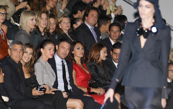 From left, George Clooney, his girlfriend  Elisabetta Canalis, Megan Fox, her husband Brian Austin Green, Indian actress Aishwarya Rai and her husband Abhishek Bachchan attend the presentation of the Armani Spring-Summer 2011 fashion collection, during the fashion week in Milan, Italy. (AP)