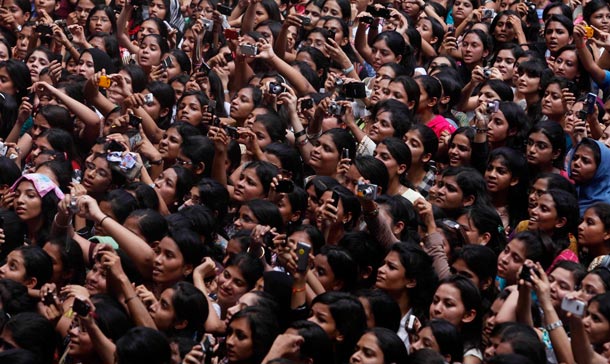 Indian students take photographs of Bollywood actors Priyanka Chopra and Ranbir Kapoor, unseen, during a promotional event in Hyderabad, India. (AP)