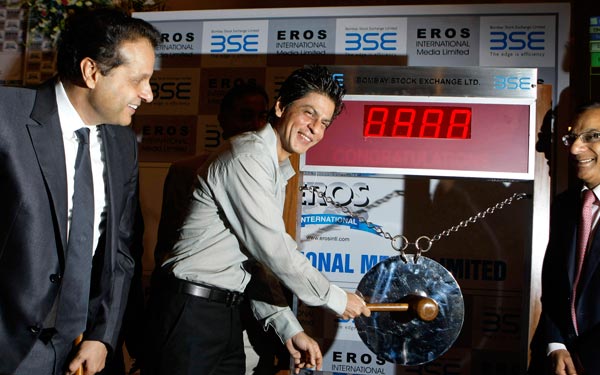 Bollywood actor Shah Rukh Khan, center, hits the gong for the listing of Eros International Media (EIM) at the Bombay Stock Exchange (BSE) in Mumbai, India. (AP)