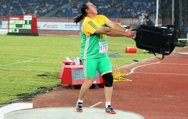 Christiaan Harmse of South Africa jokes around as he pretends to throw a bag after competing in the men's hammer final during day five of the Delhi 2010 Commonwealth Games. (GETTY)