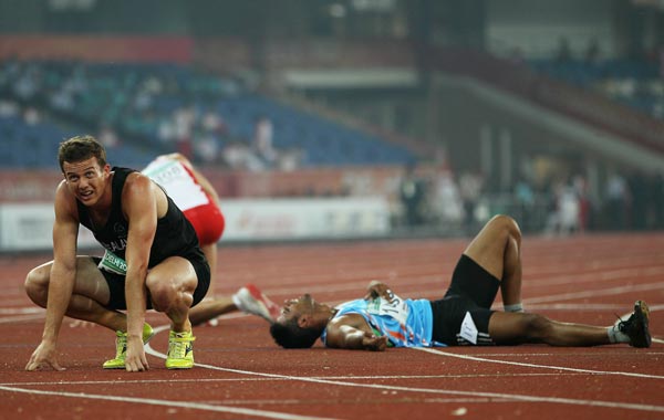 Brent Newdick (L) of New Zealand looks towards the scoreboard after competing in the men's 1500 metres in the men's decathlon during day five of the Delhi 2010 Commonwealth Games at the Jawaharlal Nehru Stadium. (GETTY)