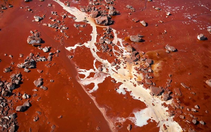 An aerial view of a field covered with red mud and rocks torn away from a reservoir wall by a sludge flood in Kolontar, 167 km southwest of Budapest, Hungary. (EPA)