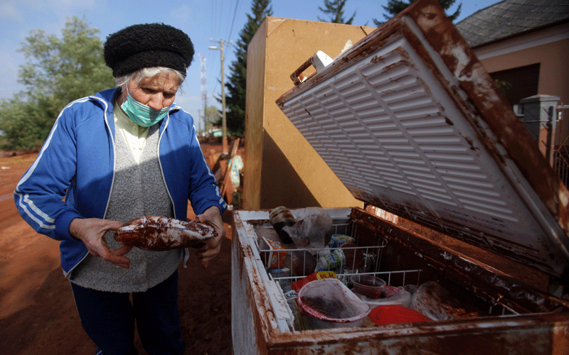 A local elderly woman opens her fridge as she stands in front of her house in the flooded town of Devecser, 150 km (93 miles) west of Hungarian capital Budapest. (AFP)