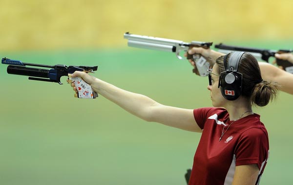 Dorothy Ludwig of Canada fires a shot during the women's pairs 10 m air pistol event of the XIX Commonwealth Games at the Karni Singh shooting range in New Delhi. (AFP)