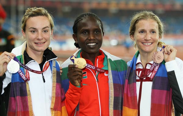 (L-R) Silver medalist Nikki Hamblin of New Zealand, gold medalist Nancy Lan'gat of Kenya and bronze medalist Diane Cummins of Canada celebrate on the podiunm with their medals for the women's 800 metres final at Jawaharlal Nehru Stadium during day eight of the Delhi 2010 Commonwealth Games. (GETTY)