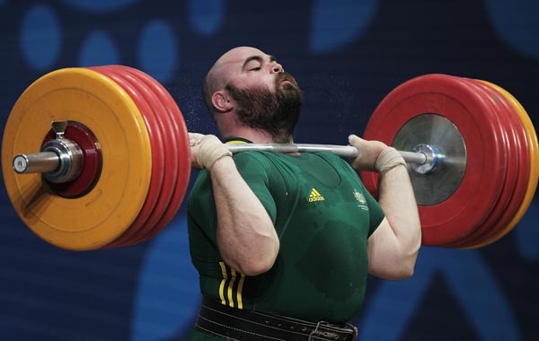 Damon Kelly of Australia lifts in the Clean and Jerk on his way to winning the Gold Medal in the mens 105+kg Weightlifting competition at JN Sports Complex during day eight of the Delhi 2010 Commonwealth Games. (GETTY)