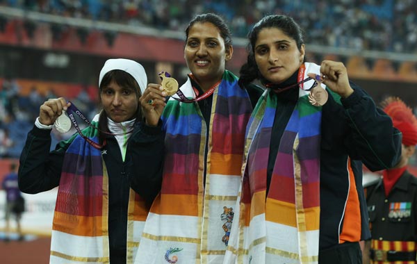 (L-R) Silver medalist Harwant Kaur of India, gold medalist Krishna Poonia of India and bronze medalist Seema Antil of India celebrate on the podium with their medals for the women's discus at Jawaharlal Nehru Stadium during day eight of the Delhi 2010 Commonwealth Games. (GETTY)