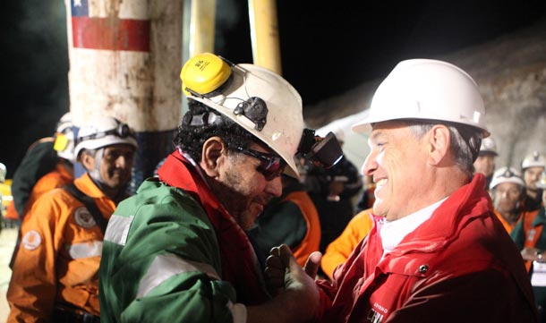 Chilean President Sebastian Pinera speaks with the last miner to be rescued, Luis Urzua, credited with organizing the miners to ration food and save themselves, at the end of the operation at the San Jose mine in Copiapo. All of Chile's 33 trapped miners were rescued from deep underground in a special capsule on Wednesday as an extraordinary two-month survival story many call a miracle triggered wild celebrations. (REUTERS)