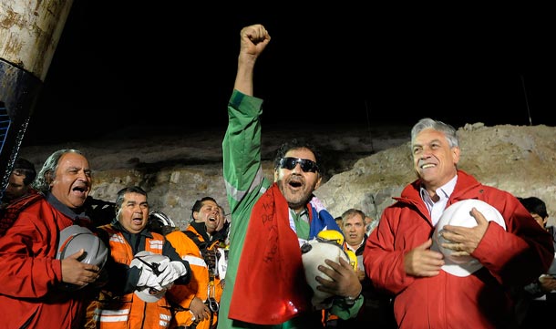 The last miner to be rescued, Luis Urzua, who is credited with organizing trapped miners to ration food and save themselves, gestures next to Chilean President Sebastian Pinera (R) at the end of the rescue operation at San Jose mine in Copiapo. (REUTERS)