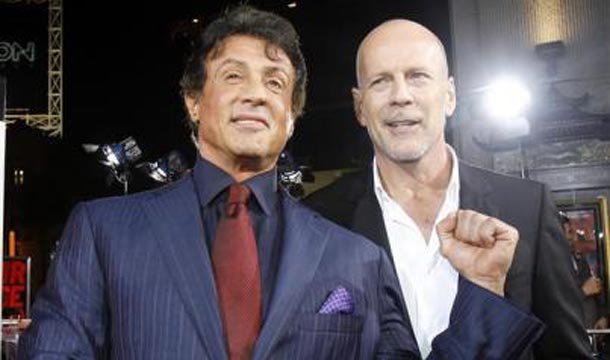 Sylvester Stallone gestures as he poses with cast member Bruce Willis at a special screening of the movie "Red" at the Grauman's Chinese theatre in Hollywood. (REUTERS)