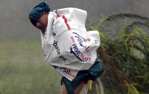 A Filipino villager manuevers against  Typhoon Megi's strong winds and rains   in Isabela province, northern Philippines. (EPA)