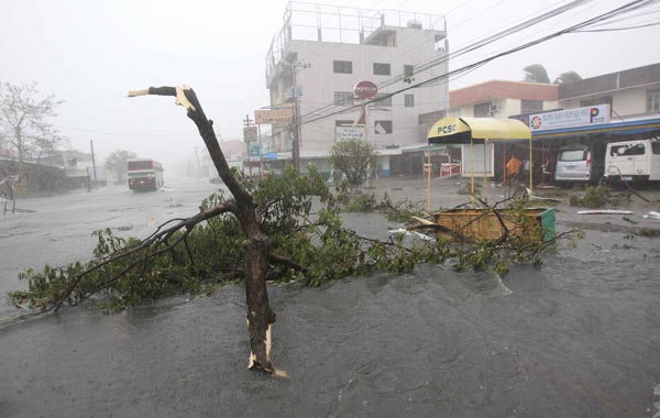 The strongest cyclone in years to buffet the Philippines knocked out communications and power as residents took shelter. (AP)