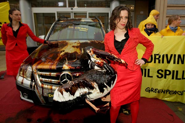 Greenpeace activists splatter luxury cars with oil six months after the Deepwater Horizon oil rig explosion, mocking industry car shows, in front of the office of European carmaker association ACEA in Brussels , Belgium. (EPA)